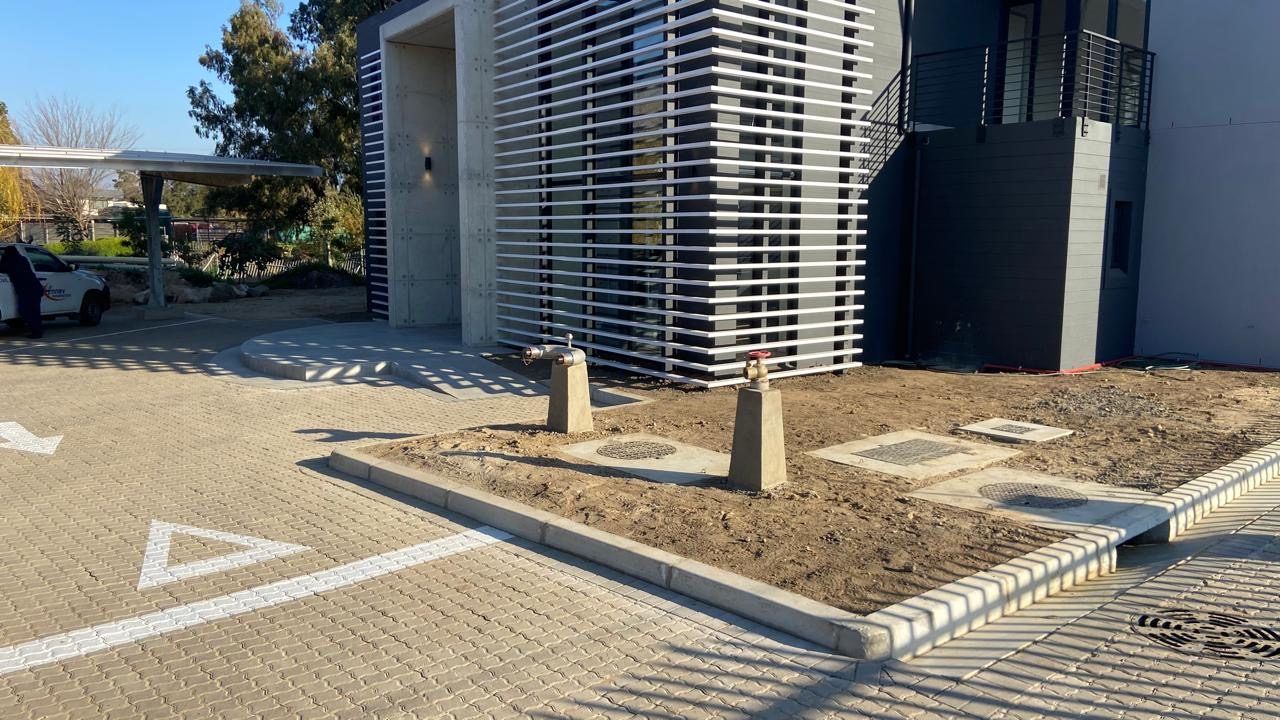 Paved entrance apron with kerbed islands